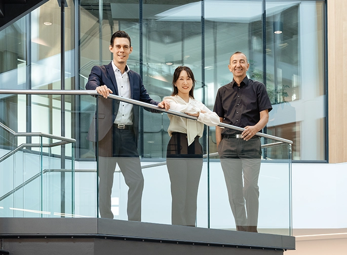 Three Bechtle employees are standing on the steps in the office. (photo)