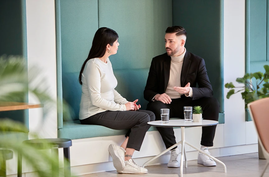 Two colleagues are engrossed in a focused conversation.